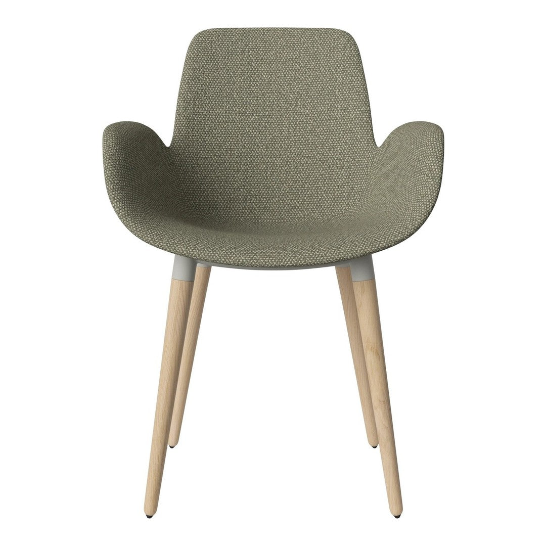 Green textured chair with smooth wooden legs, featuring a modern, minimalist design perfect for contemporary spaces.