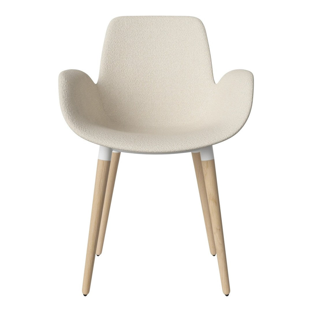 Beige upholstered chair with natural wood legs, minimalistic design, and smooth, seamless curves. Perfect for modern decor.