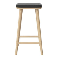 Black padded top on natural wood legs bar stool with a simple, modern design. Ideal for stylish interiors.
