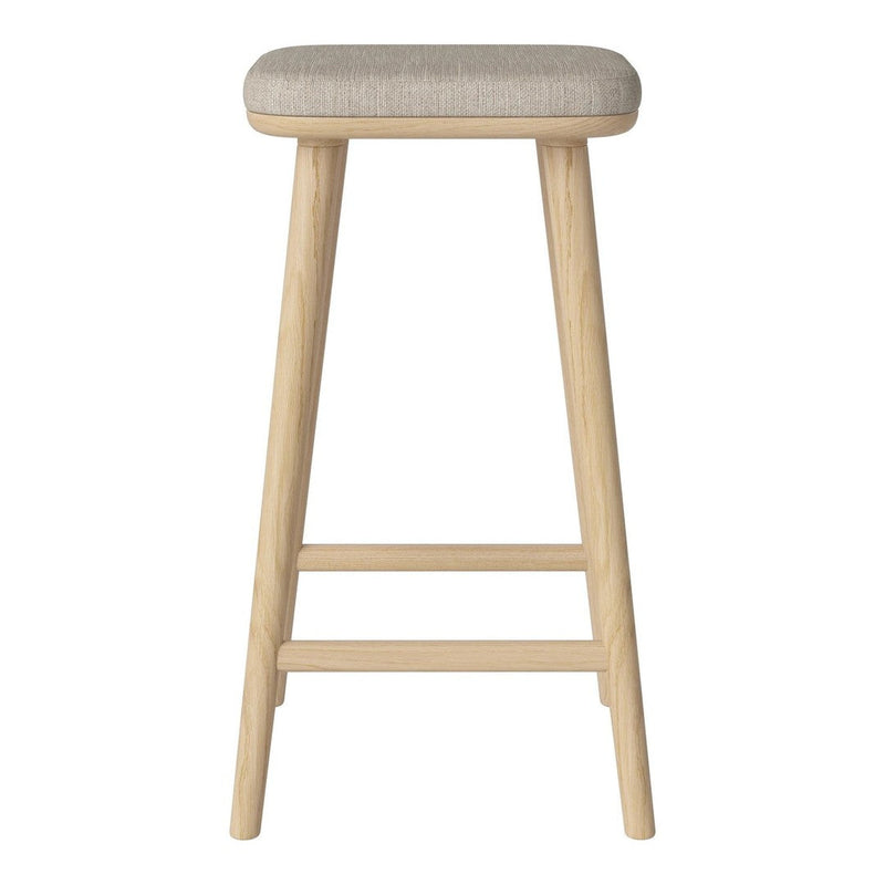 Light beige upholstered stool with natural wood legs, featuring a simple, modern design.