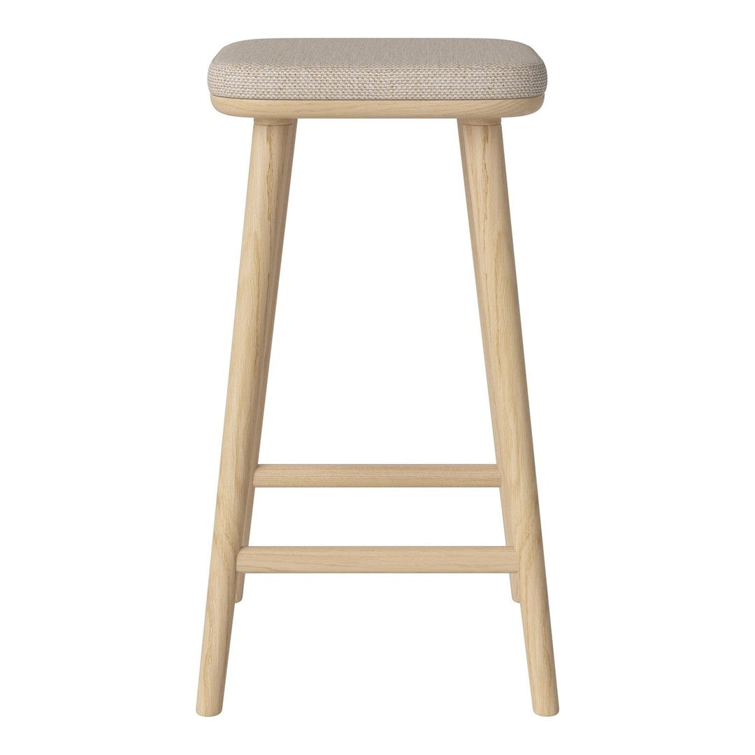 Beige cushioned seat on natural wood legs, featuring a minimalist design with smooth textures and subtle tones.