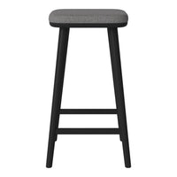 Black wooden stool with a subtle gray upholstered seat, emphasizing a modern, minimalist design.