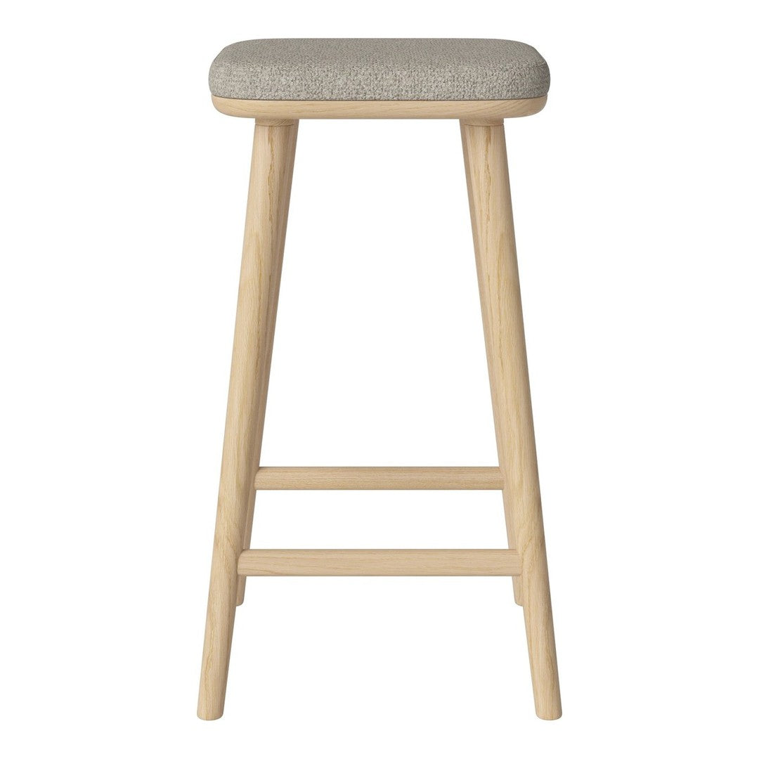 Light wood bar stool with a textured gray fabric seat. Minimalist design featuring soft, neutral tones.