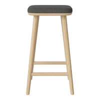 Gray upholstered stool with a natural wood base, featuring a minimalist design. Perfect for modern interiors.