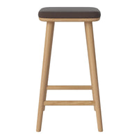 Brown upholstered seat on natural wood legs, featuring a sleek and minimalist design. Perfect for modern decor.