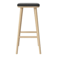 Light wood bar stool with a sleek black cushion seat, perfect for modern decor. Minimalist design with no patterns.