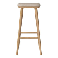 Light beige upholstered bar stool with natural wood legs, showcasing a minimalist design and soft texture.