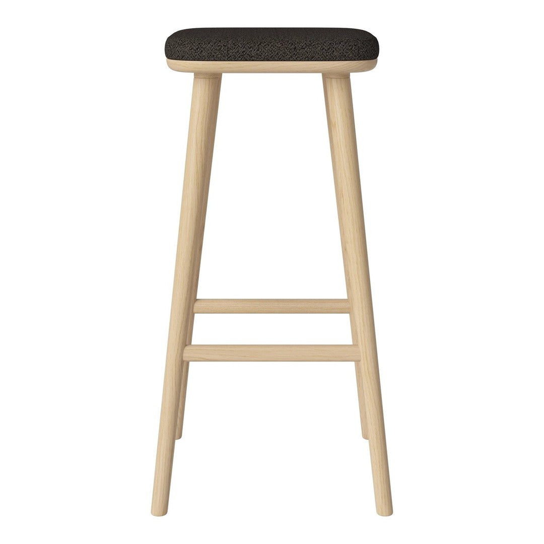 "Light wood bar stool with a dark fabric seat, featuring a minimalist design and clean lines."