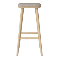 Light wood bar stool with a textured gray upholstered seat. Simple, modern design with natural tones.