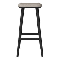 Black wooden bar stool with a light gray upholstered seat, featuring a simple, modern design.