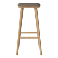 Bar stool with a natural wood finish and a textured gray fabric seat. Modern and minimalist design.