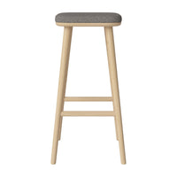 Light wood bar stool with a textured gray fabric seat, showcasing a minimalist and modern design.