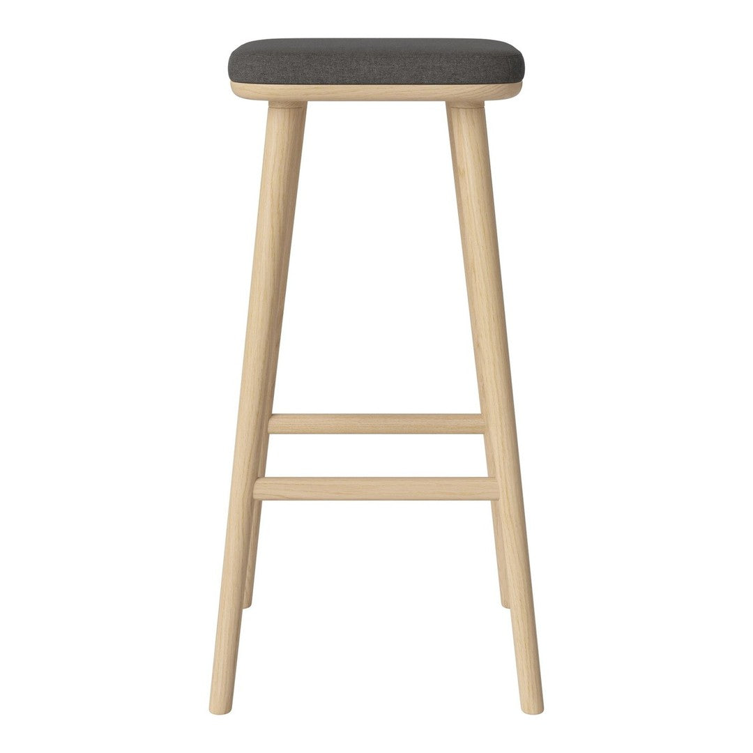 Minimalist wooden bar stool with a light natural finish and a dark gray upholstered seat. Simple, modern design.