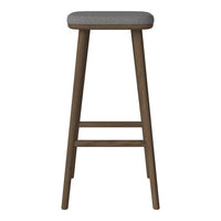 Gray upholstered stool with a natural wood finish and simple design. Perfect for modern decor.