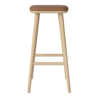 Light wooden bar stool with a smooth brown leather seat, featuring a minimalist design and natural wood finish.