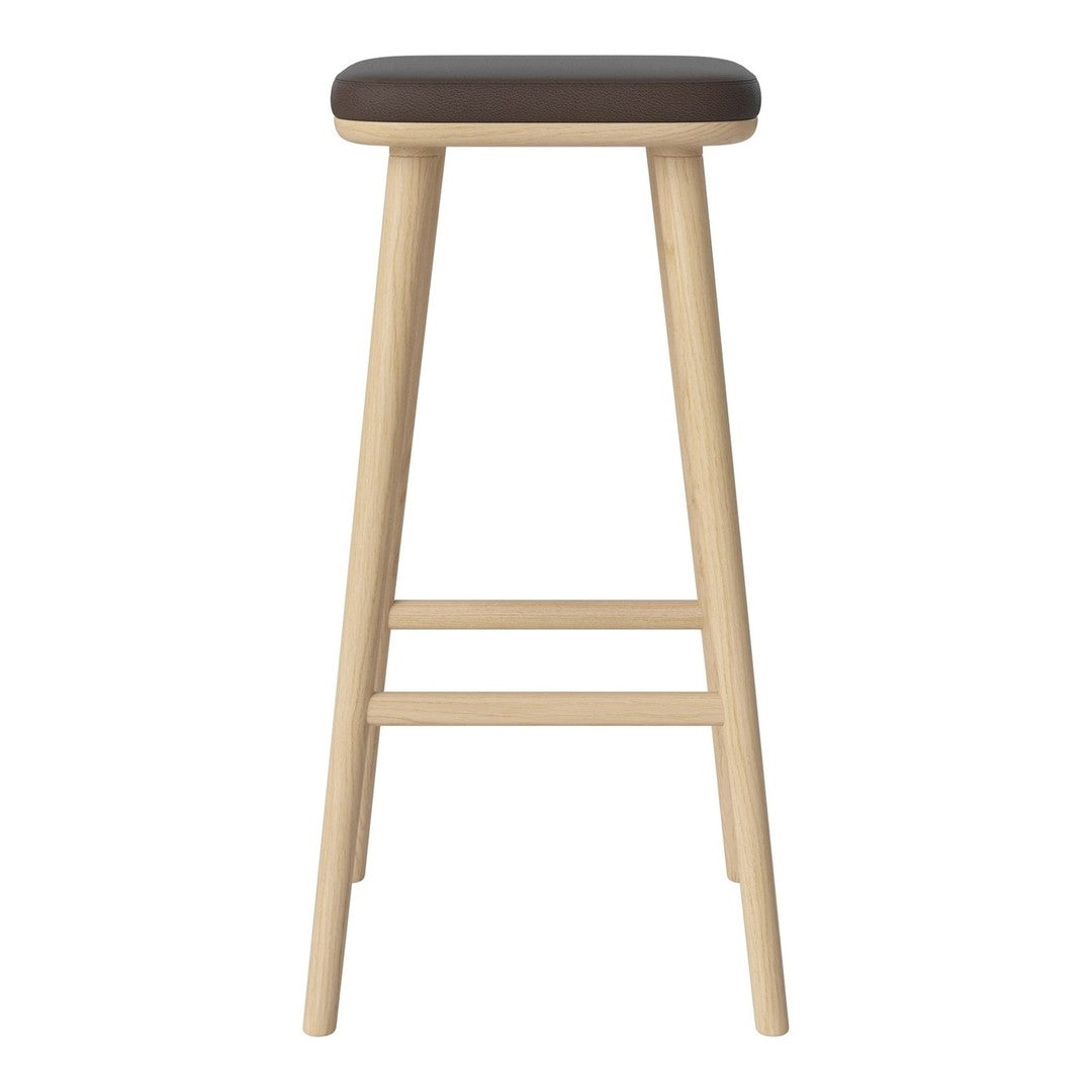 Brown upholstered stool with natural wood legs, featuring a minimalist design and smooth surfaces.