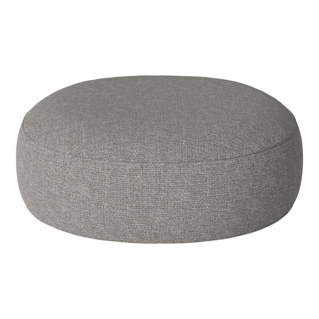Round gray pouf with a textured fabric, perfect for modern decor. Soft, neutral color complements various styles.