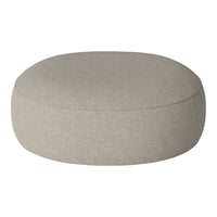 Round ottoman in light beige fabric with a smooth, textured finish, perfect for adding style to any room.