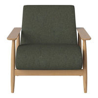 "Green upholstered armchair with a textured pattern and light wood accents."