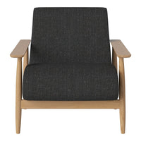 Modern black upholstered armchair with a textured fabric and light wooden frame. Elegant and minimalist design.