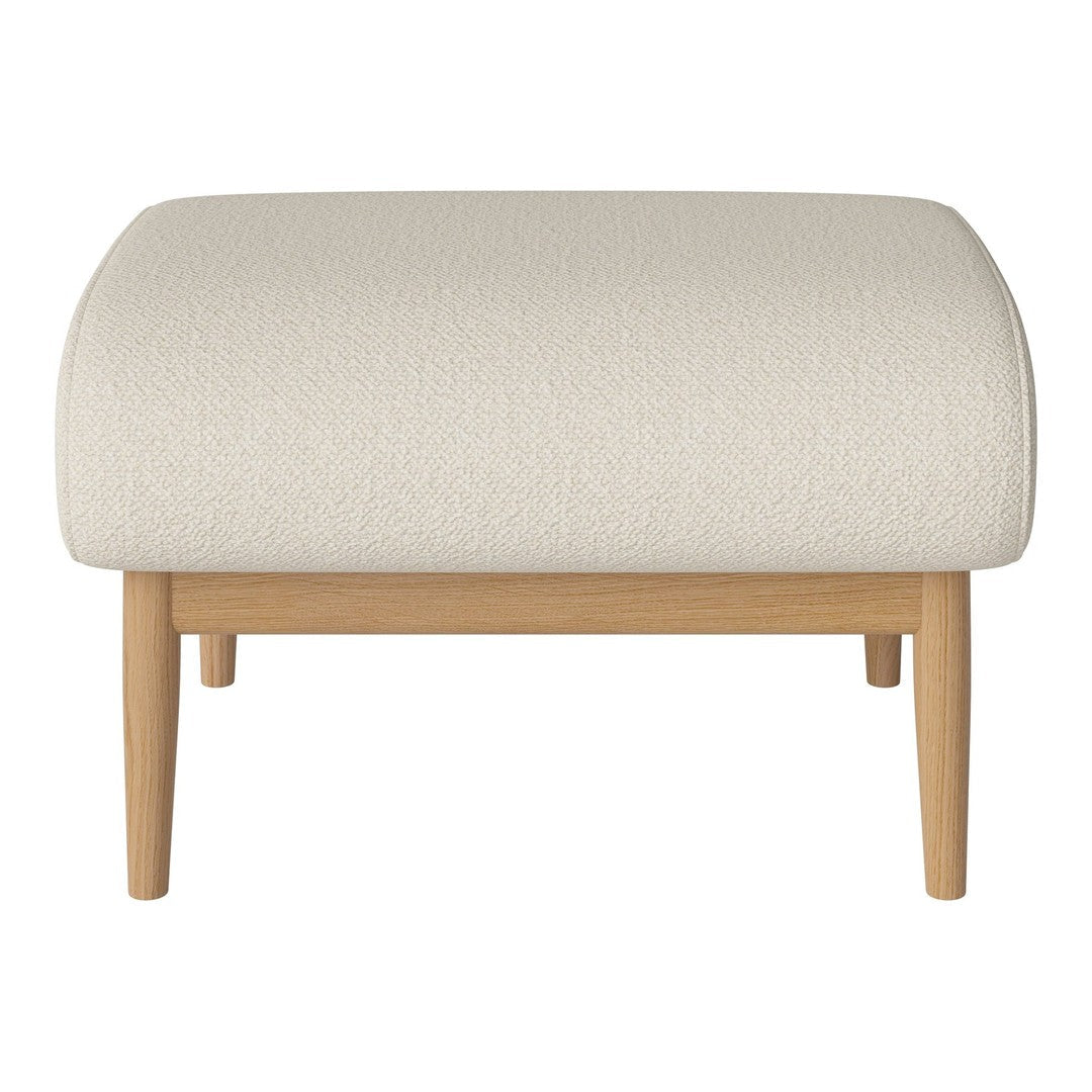 Neutral cream ottoman with a textured surface and natural wood legs, perfect for modern, minimalist decor.