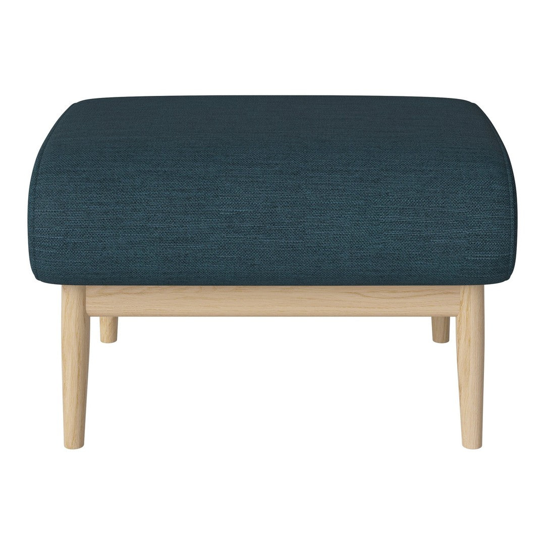 Teal upholstered ottoman with textured fabric, featuring natural wood legs for a modern contrast.