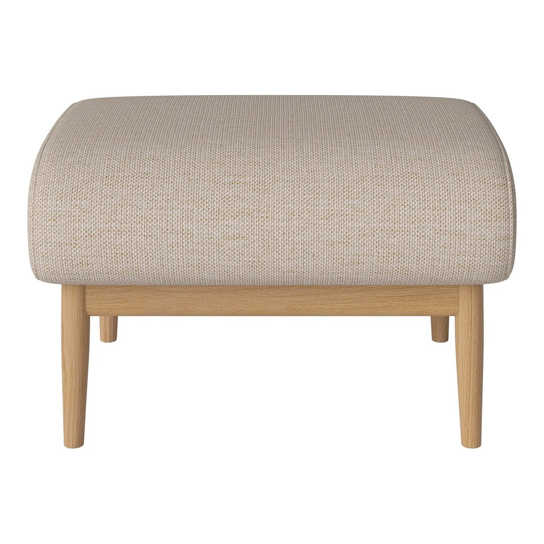 Beige textured ottoman with a rounded top and light wood legs, perfect for modern decor.