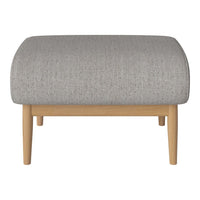 Gray upholstered ottoman with a textured finish and light wood legs, featuring a smooth, rounded silhouette.