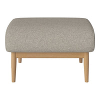 Light gray upholstered ottoman with a textured fabric and natural wood legs, showcasing a minimalist design.