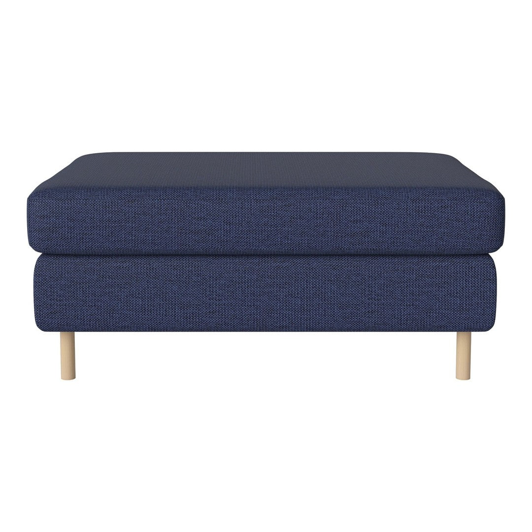 Navy blue upholstered ottoman with a smooth texture and natural wooden legs. Modern minimalist design for stylish interiors.