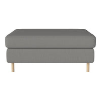 Gray upholstered ottoman with a smooth texture and natural wood legs, perfect for modern decor.