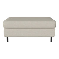 Beige fabric ottoman with clean lines and black legs, perfect for modern living spaces.