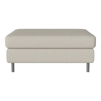 Light beige ottoman with a smooth fabric finish and minimalist design, featuring sleek metal legs.