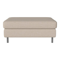 Beige fabric ottoman with a smooth texture and minimalist design, supported by silver metal legs.