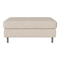 Beige textured ottoman with a soft finish, featuring a minimalist design and sleek metal legs.