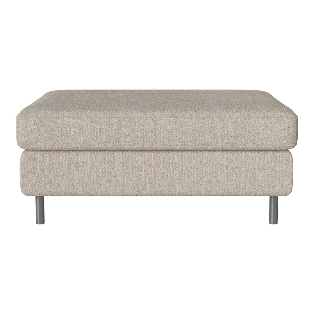 Light beige ottoman with a textured fabric finish and sleek silver legs, perfect for modern decor.