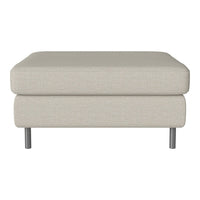 Light beige upholstered ottoman with a minimalist design and subtle textured fabric on silver legs.