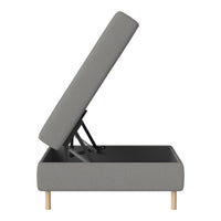 Gray upholstered storage bed with a simple, modern design and light wooden legs.