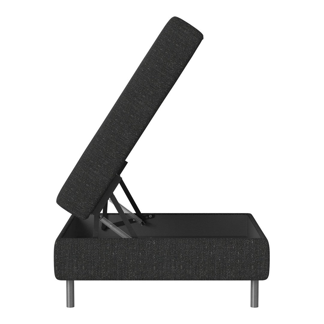 Black upholstered storage ottoman with a textured pattern and silver metal legs, partially opened to reveal interior space.