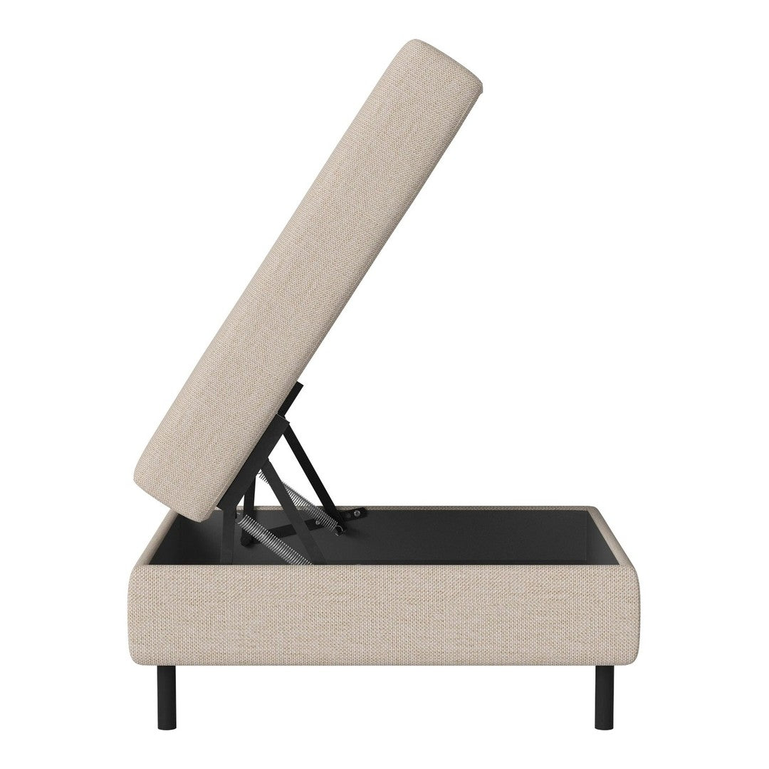 Beige upholstered storage ottoman with a subtle texture and black frame. Modern design, ideal for any decor.