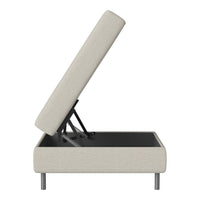 Light beige upholstered storage ottoman with modern gray legs and minimalist design.
