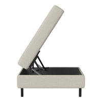 Light beige upholstered storage ottoman with sleek black legs and a simple, modern design.