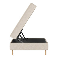 Light beige upholstered storage bed with clean lines and natural wooden legs. Simple, modern design.