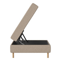 Beige upholstered ottoman with a minimalist design and natural wood legs; features a smooth, textured fabric.