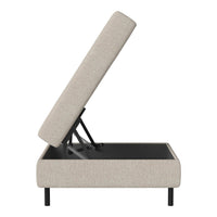 Beige upholstered storage ottoman with a sleek black base and modern design, showcasing a minimalist style.