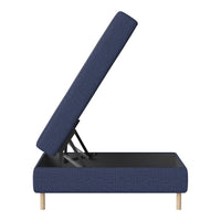 Navy blue upholstered storage bed with a sleek modern design and light wooden legs.