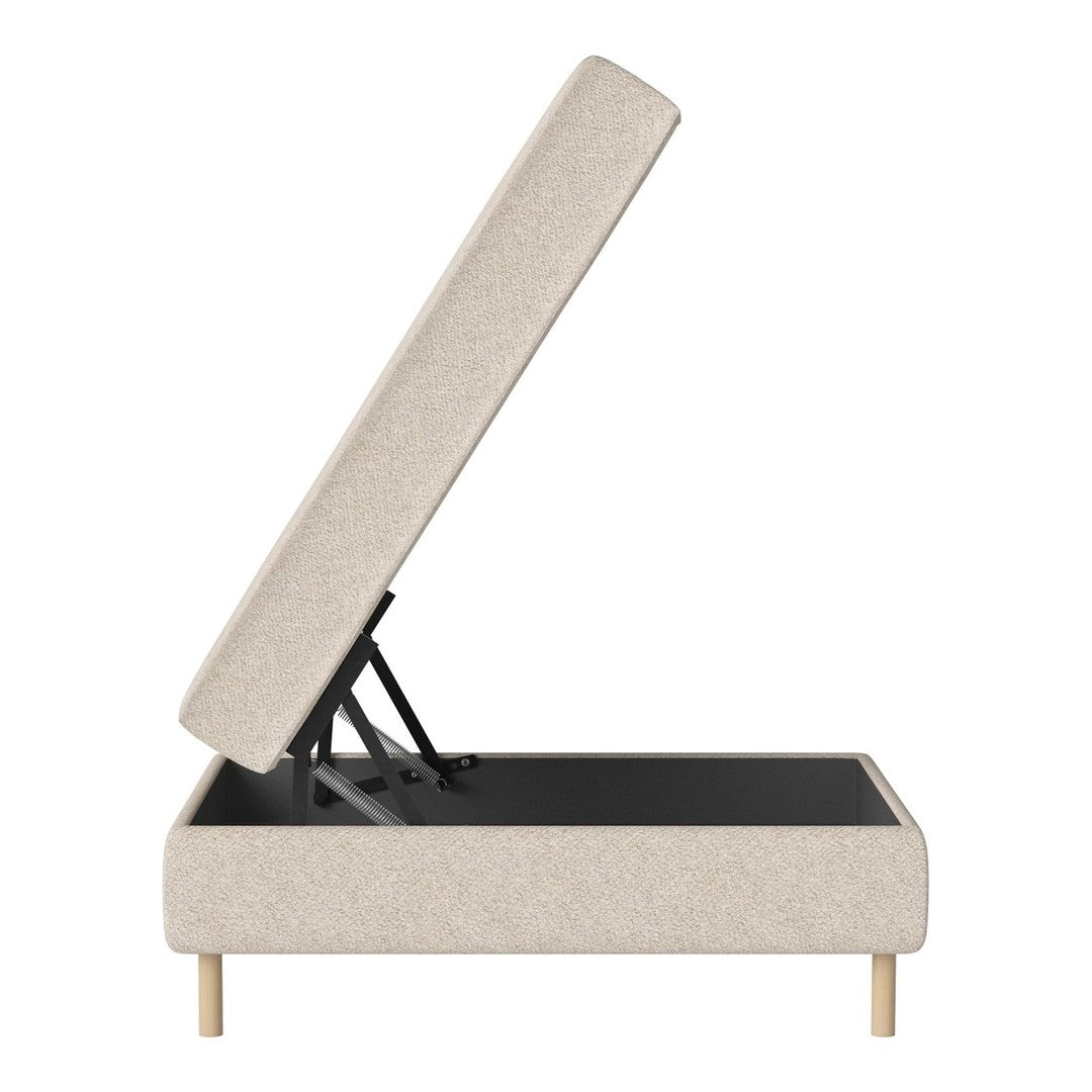 Beige upholstered storage bed with a minimalist design and light wood legs, showcasing a sleek, modern look.
