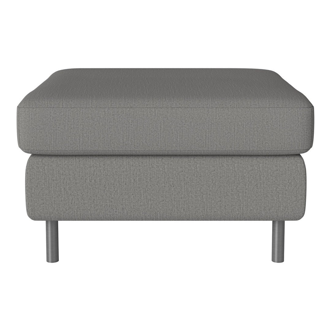 Gray upholstered ottoman with a sleek, textured pattern and silver metal legs. Perfect for modern decor.