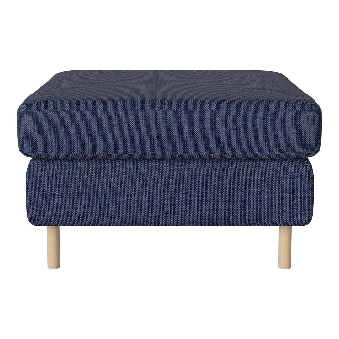 Navy blue upholstered ottoman with textured fabric and light wooden legs. Stylish and modern home decor accent.