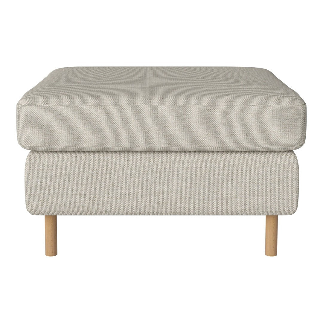 Light beige ottoman with a textured fabric finish and natural wood legs. Versatile and modern design for any space.